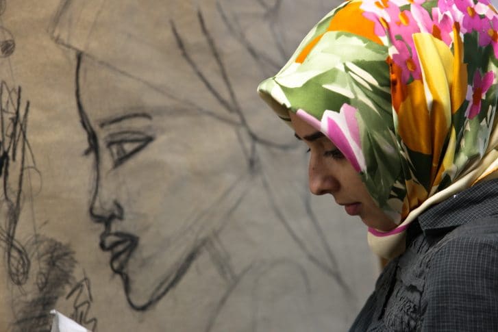 A woman has alcohol poured over her on a train and no one helps, because she’s Muslim