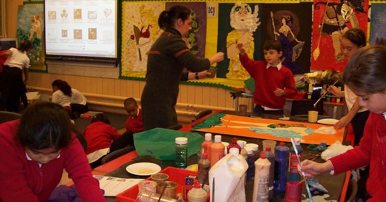 Young children and their teacher in a classroom