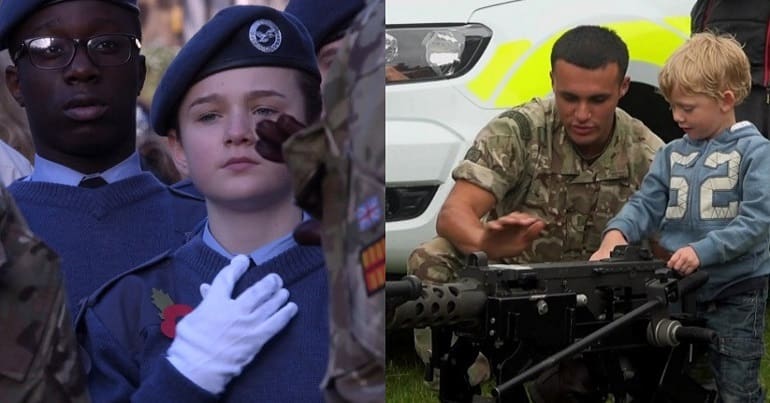 Child cadet with hand on heart and little one with heavy arsenal