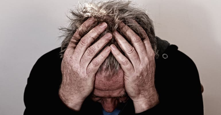 Man with head in hands