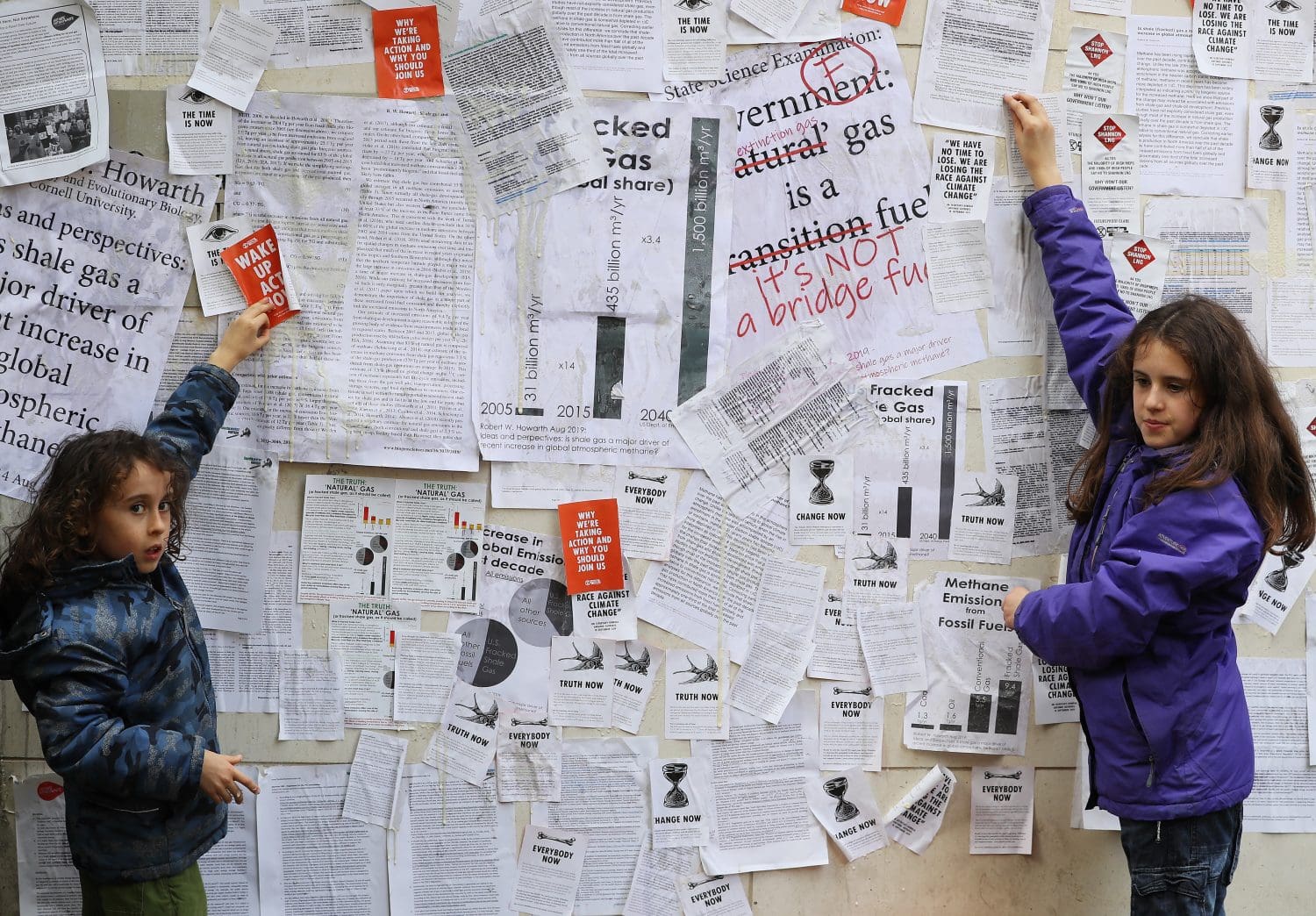 Climate breakdown activists ‘wallpaper’ government department with science reports