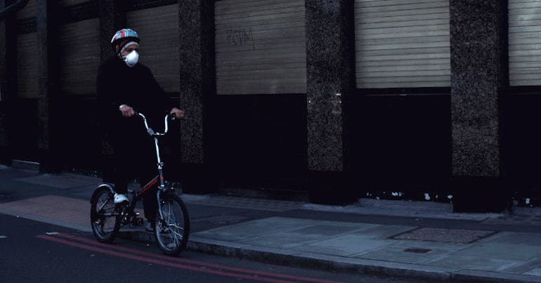Man in face mask on bike