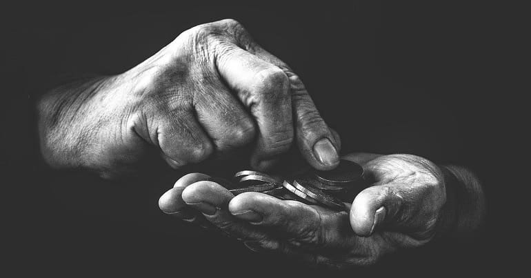 A pair of hands counting change amid coronavirus