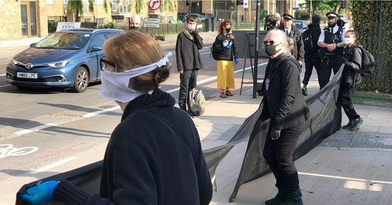 Protesters against HS2 hold a banner