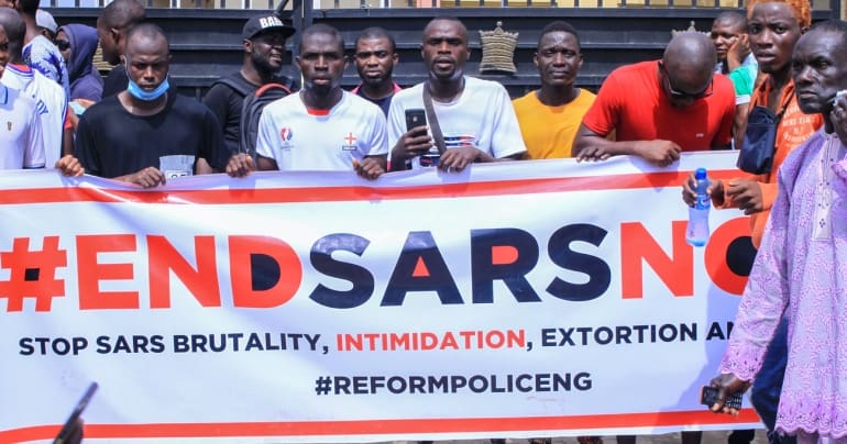 Protesters holding #EndSARSNow banner