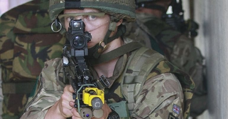 A soldier aiming a rifle