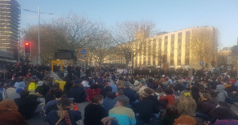 People sit down at an intersection in Bristol