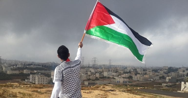 Man waving Palestinian flag