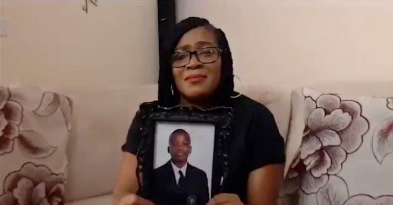 Osime Brown's mother holds a photo of her son