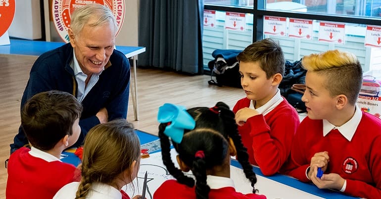 Philip Alston talking to school children