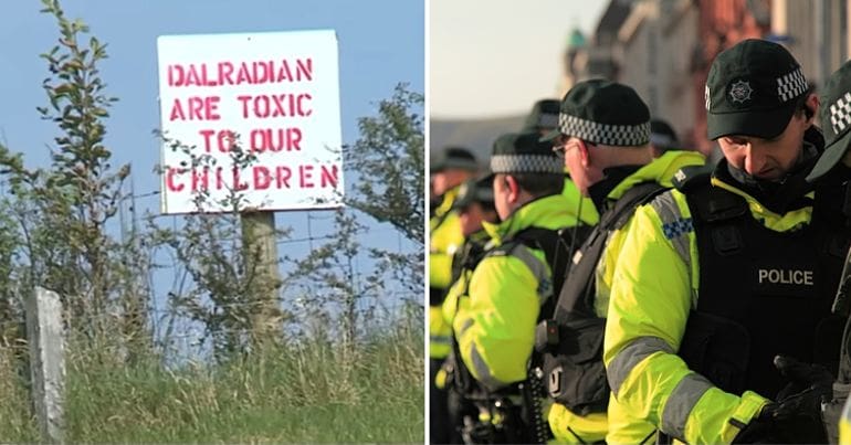 Anti-goldmine poster in a field and a line of police