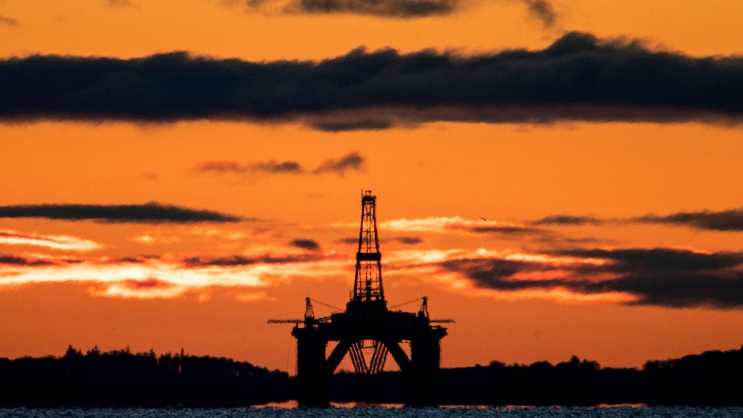 An oil rig at sunset