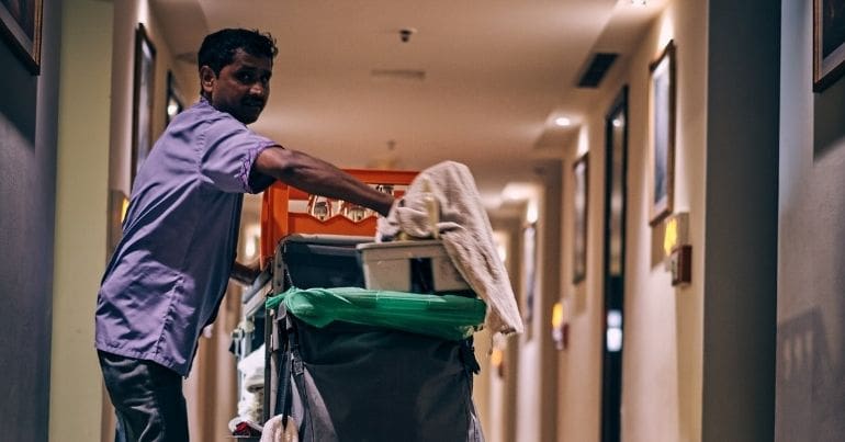 A cleaner walking down a corridor