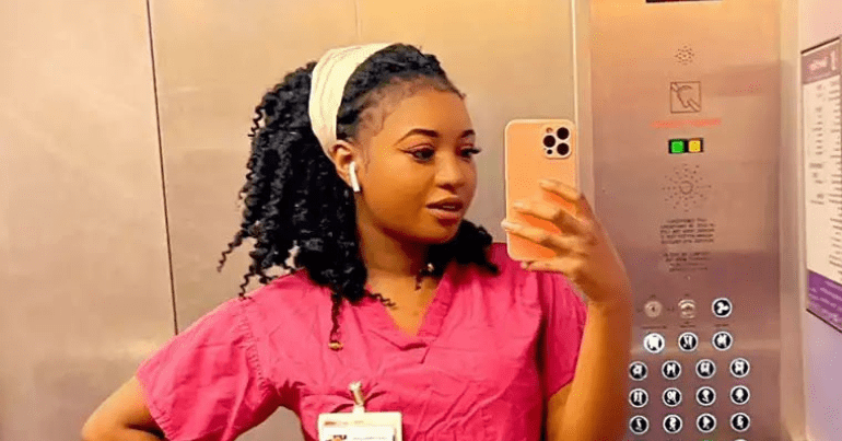 Owami Davies stands in a lift, taking a selfie