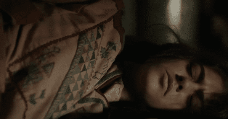 still of Farha from the film's trailer; a young girl hiding