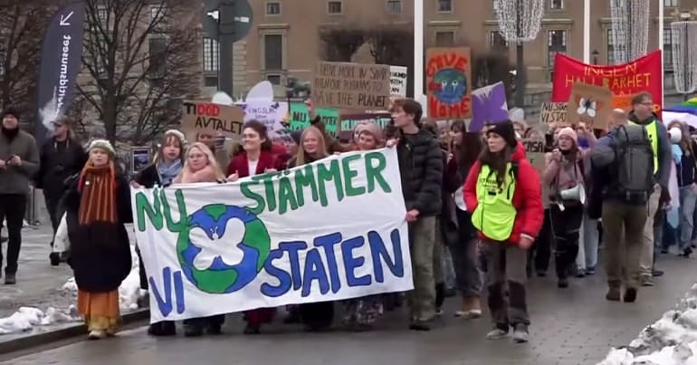 Hundreds of young people including Greta Thunberg march through Stockholm, Sweden, in November 2022 to file a climate lawsuit against the Swedish state