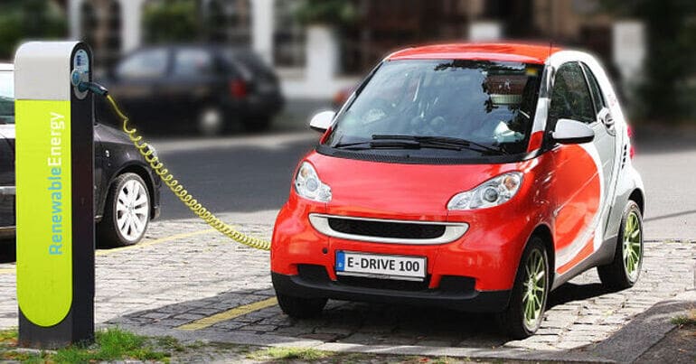 Electric car charging. Transition minerals for electric vehicles like this are driving human rights abuses in the Global South.