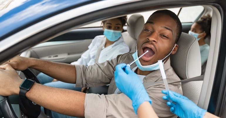 A Black family getting coronavirus testing PHE