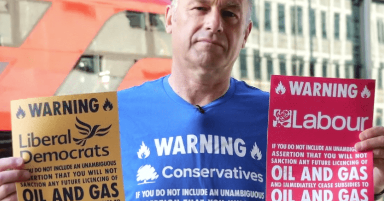 Posters which read 'Warning' in the colours of the three largest political parties that says voters won't vote for them if they sanction oil and gas