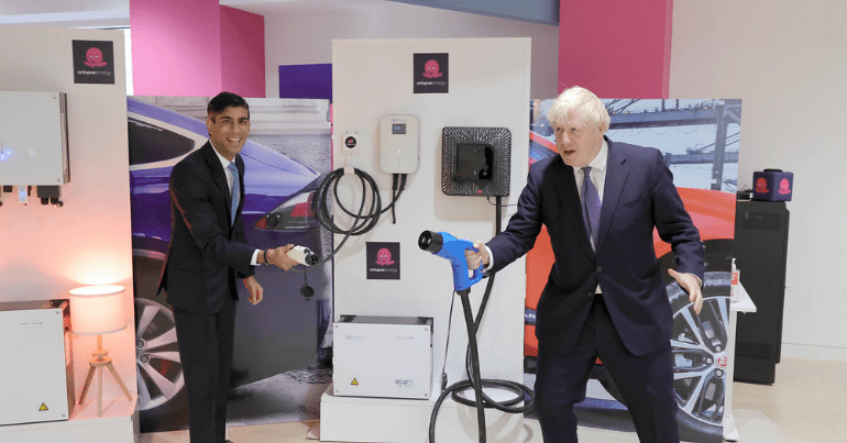 Rishi Sunak and Boris Johnson holding electric charging docks