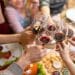 Family toasting with wine around a Christmas table