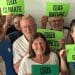 Green Party members holding signs