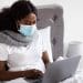 A woman wearing a mask in bed sick pay TUC