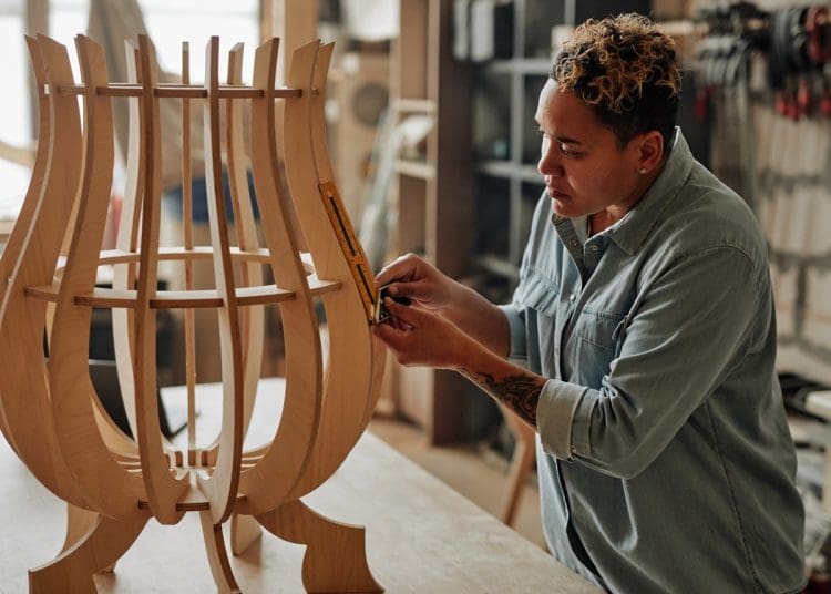 A woman crafting bespoke furniture design