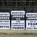 Protest placards over Judge Reid