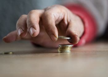 UK household spending person counting money