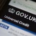 Universal Credit website on a phone DWP migration DWP benefit fraud tax credits