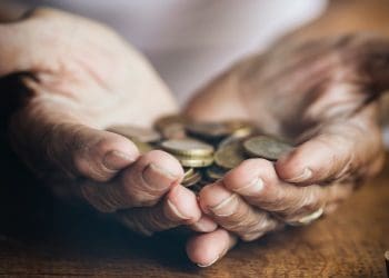 elderley hands holding coins homeowners care home costs