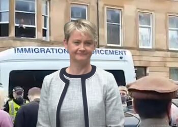 Protesters block an immigration enforcement van. A smiling home secretary Yvette Cooper Labour