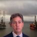 Ed Miliband with three offshore oil rigs behind him Rosebank