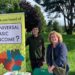 Louis Strappazzon and Alison Hawdale from the UBI Lab Network stand behind a table with campaign materials. An upright banner beside them reads: "Have you heard of a Universal Basic Income?"