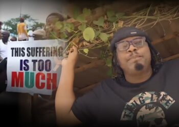 Eeedris Abdulkareem under a greenery wearing a hat, and a T-shirt that reads: THUG LIFE", with a superimposed image of Nigerian protesters carrying a placard reading: "This suffering is too much" to the left of the image.
