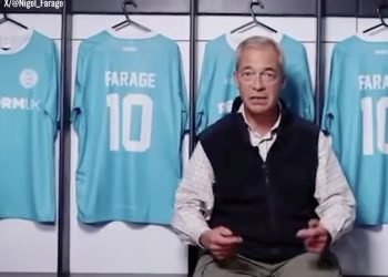 Nigel Farage in front of Reform FC shirts