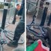 Activists use bike locks to lock-on with their bicycles to metal barricades outside Elbit Systems HQ. A Palestine flag is in view alongside them.