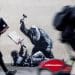 Banksy illustration of a judge beating up a protester with his gavel