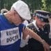 Police arresting a retired doctor at a Lift the Ban protest Defend Our Juries