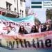 Trans rights protesters and the EHRC logo