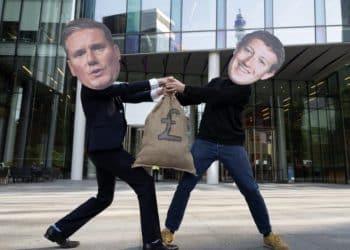 Two men in masks of Keir Starmer and Mark Zuckerberg fighting over a sack with a pound sign on it Trump
