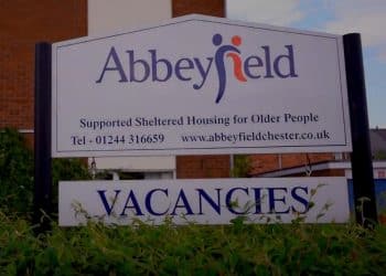 Abbeyfield Chester sign outside residences, reading: "Supported Sheltered Housing for Older People" with the telephone number and website for Abbeyfield Chester, and "VACANCIES" beneath.