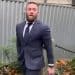 Conor McGregor in a suit walking out of court after previous case he lost.