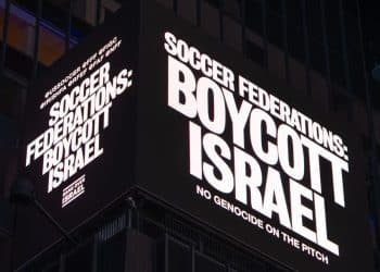 Billboard in Times Square, New York, which reads: "Soccer federations: boycott Israel. No genocide on the pitch" UN FIFA UEFA Israel