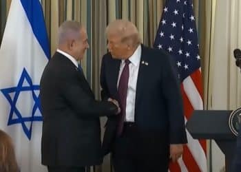 Trump and Netanyahu shake hands after a joint announcement, with the Israeli and US flags behind them Gaza plan