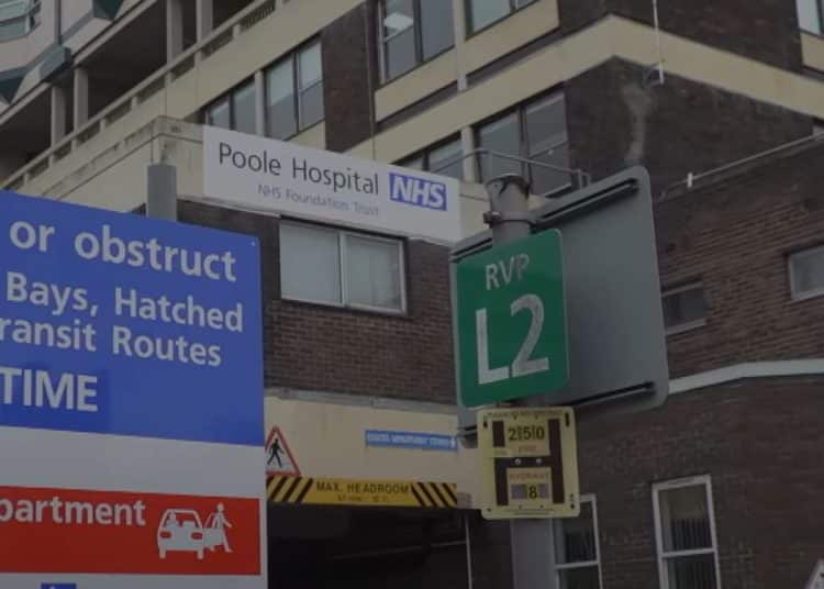 Poole Hospital sign over its ambulance ramp entrance.