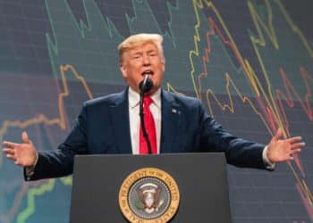 Donald Trump in front of a graph