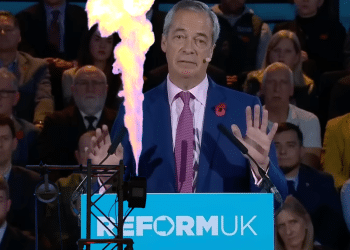 Reform UK leader addresses business leaders at press conference.